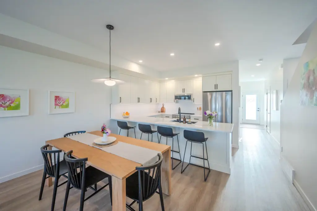 A kitchen with a table and chairs in it.