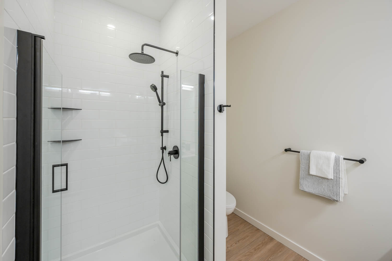 Bathroom with shower, toilet, and towel rack